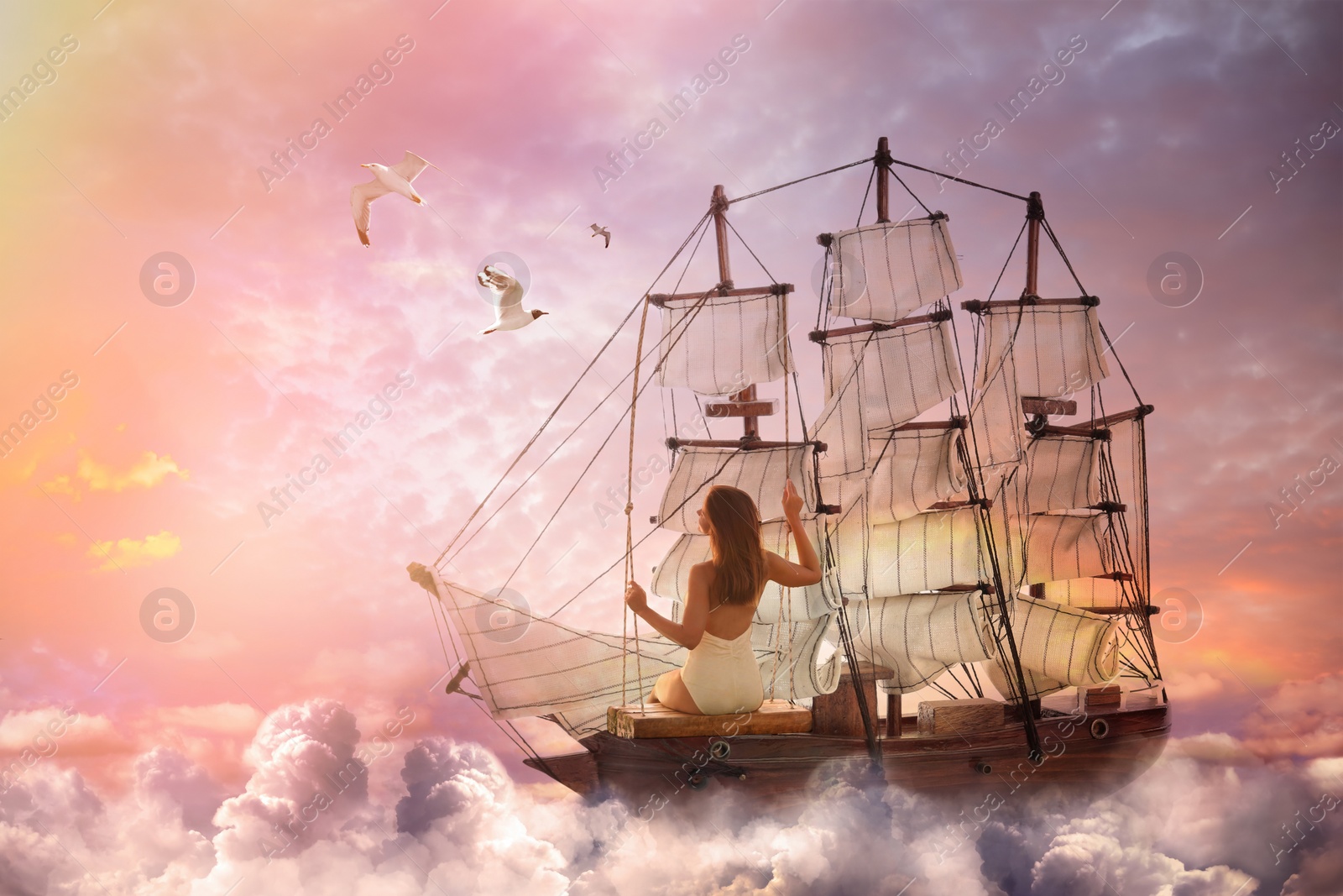 Image of Dream world. Sailing ship with beautiful girl on board floating among wonderful fluffy clouds