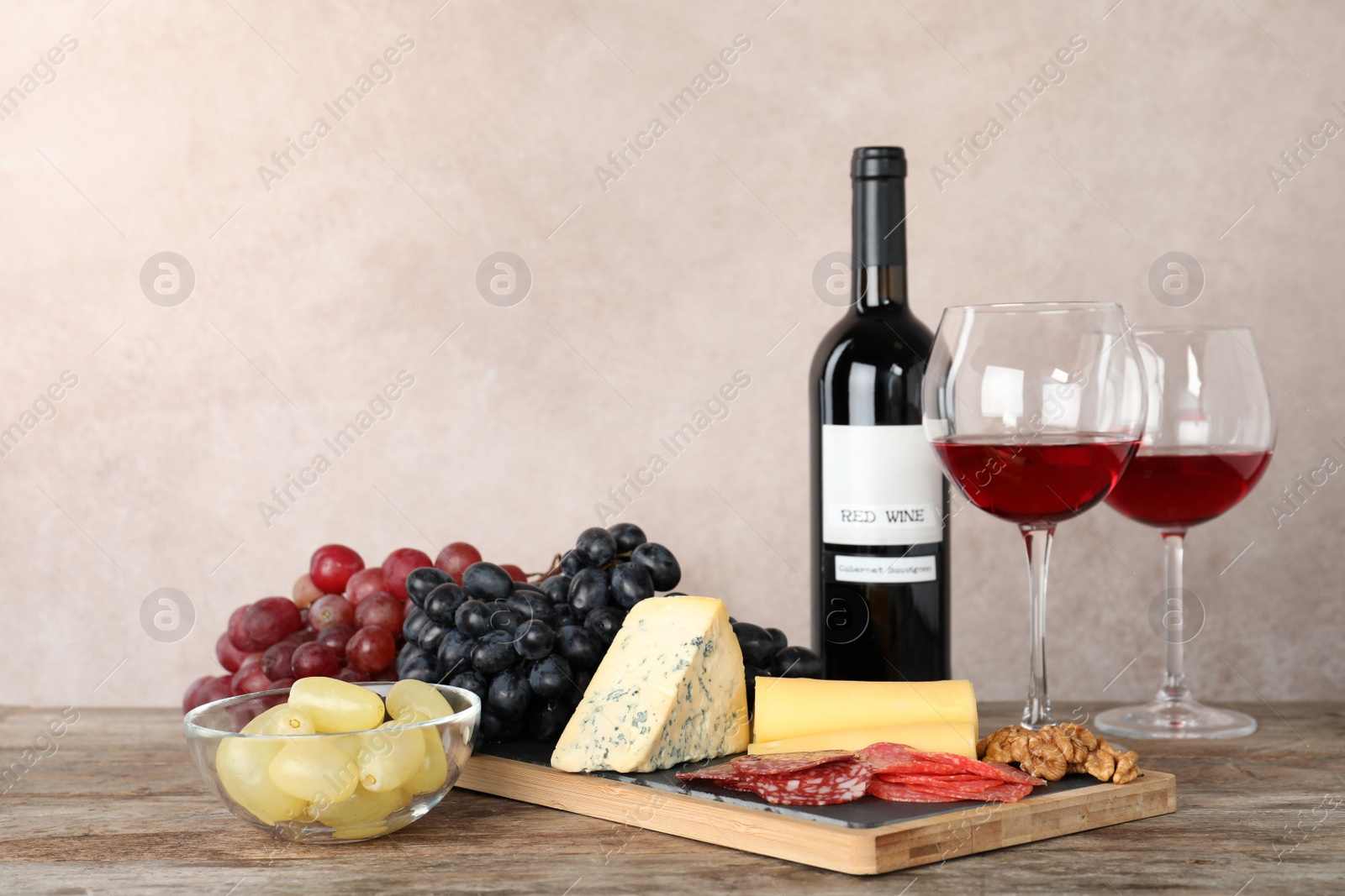 Photo of Composition with wine and snacks on table. Space for text