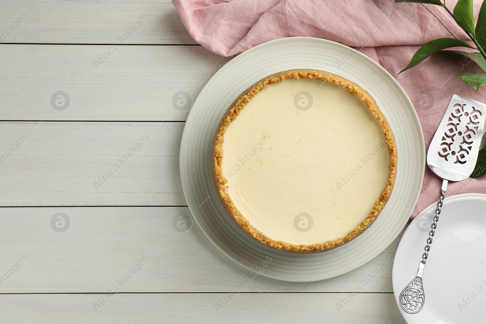 Photo of Tasty vegan tofu cheesecake served on white wooden table, flat lay. Space for text