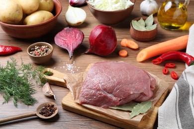 Photo of Fresh ingredients for borscht on wooden table
