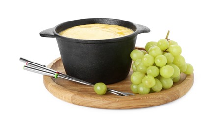 Photo of Fondue with tasty melted cheese, forks and grapes isolated on white