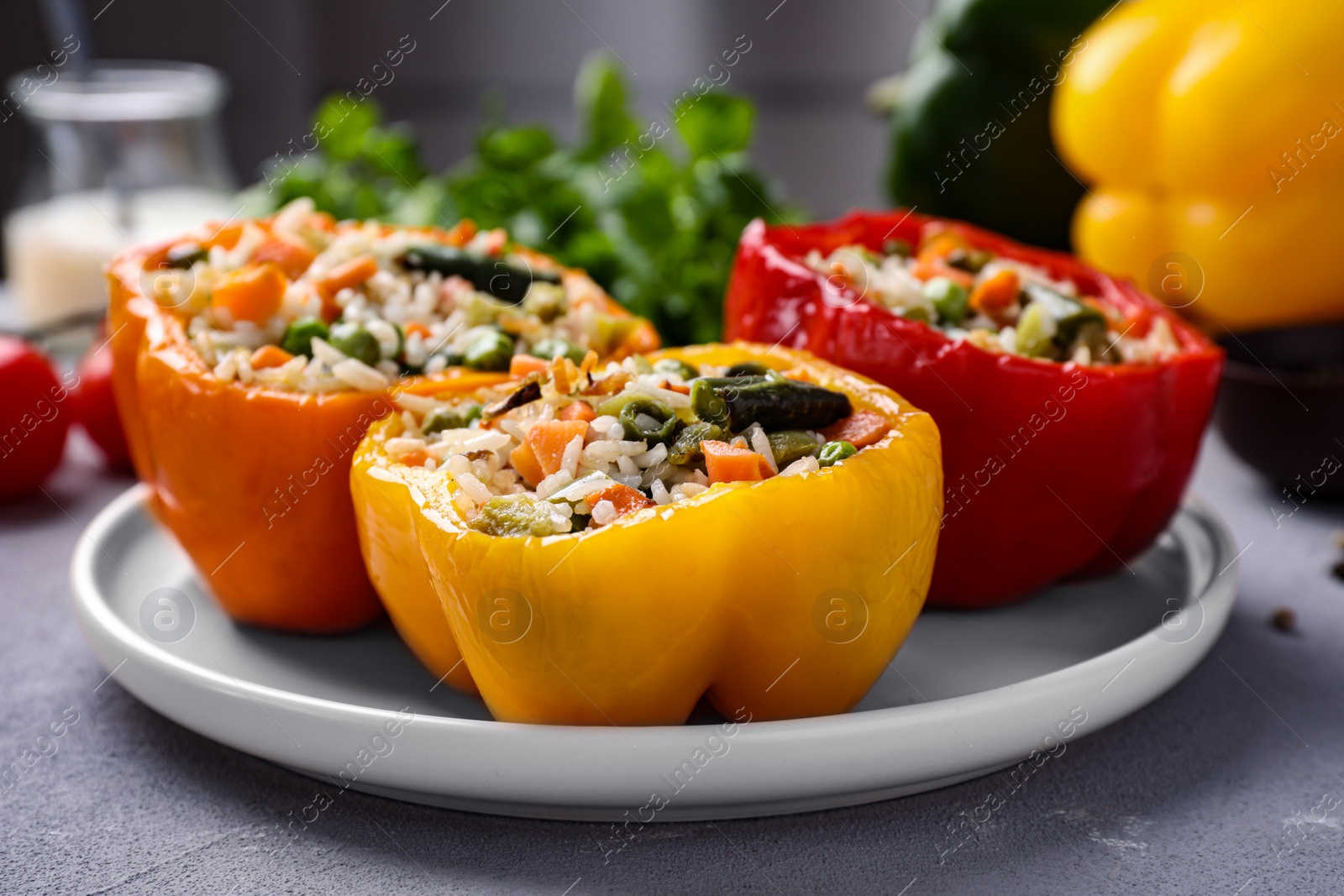 Photo of Tasty stuffed bell peppers on grey table