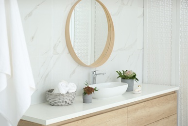 Modern bathroom interior with stylish mirror and vessel sink