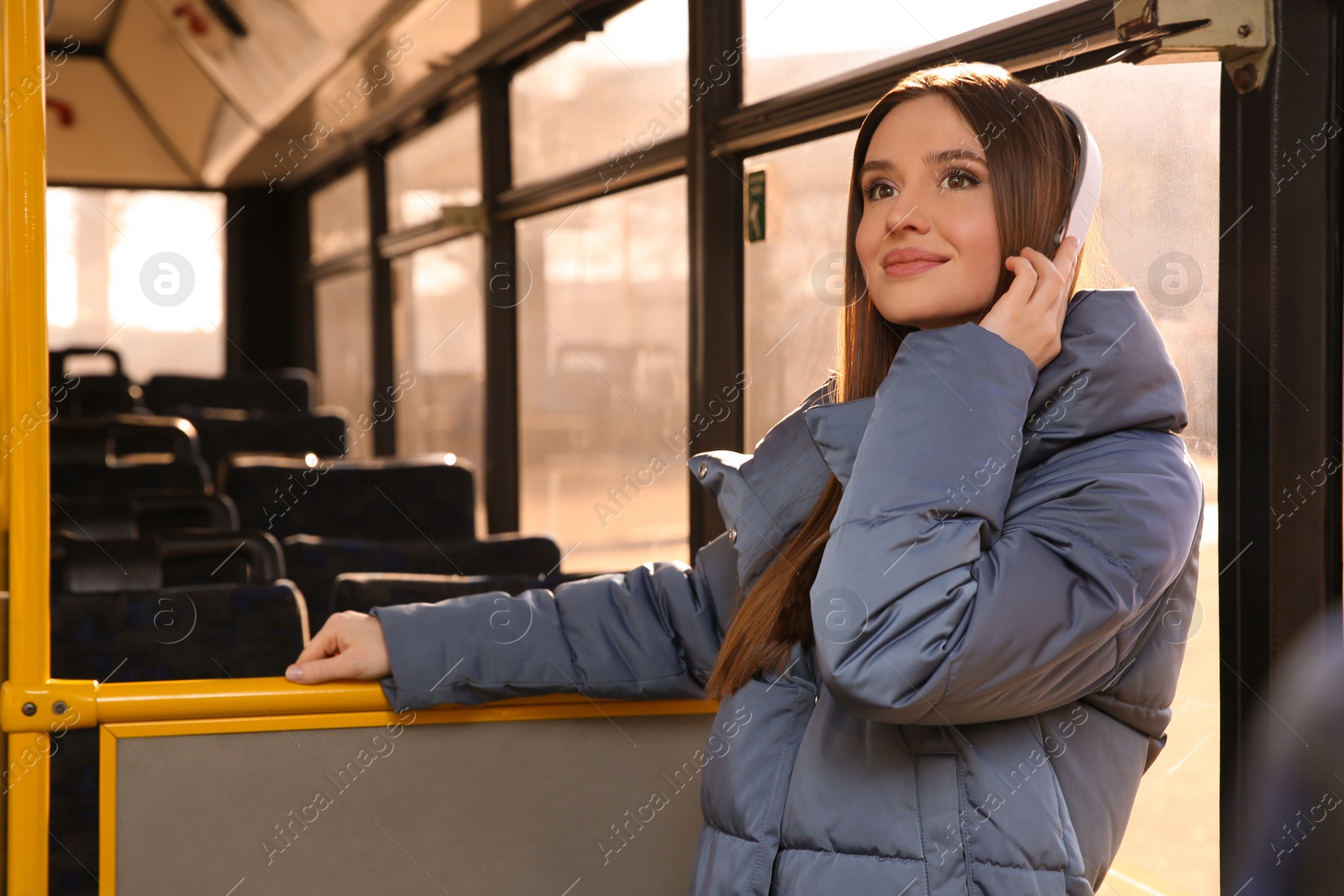 Photo of Woman listening to audiobook in trolley bus