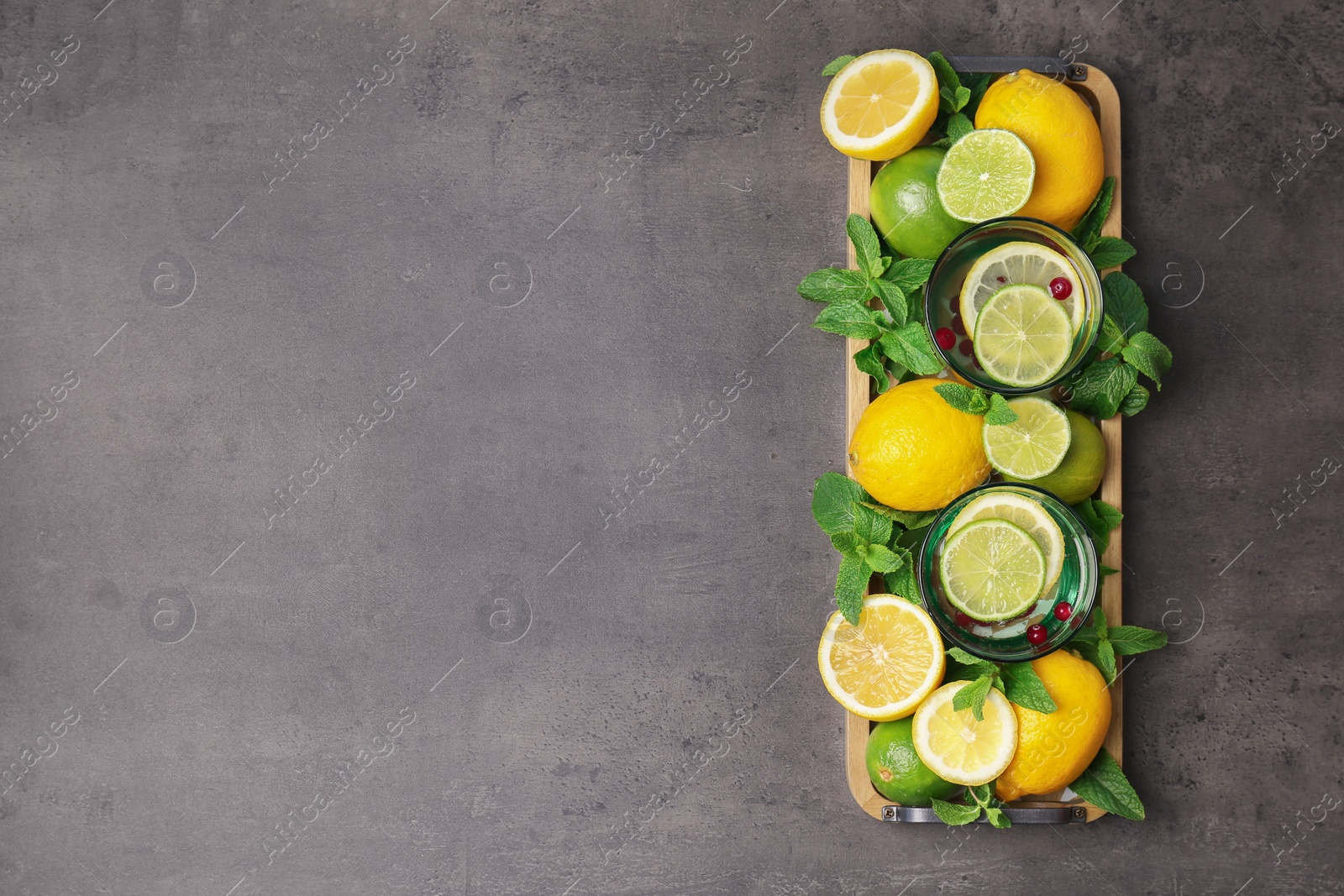 Photo of Flat lay composition with detox lemonade and ingredients on grey background