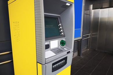Photo of Modern automated teller machine near building outdoors
