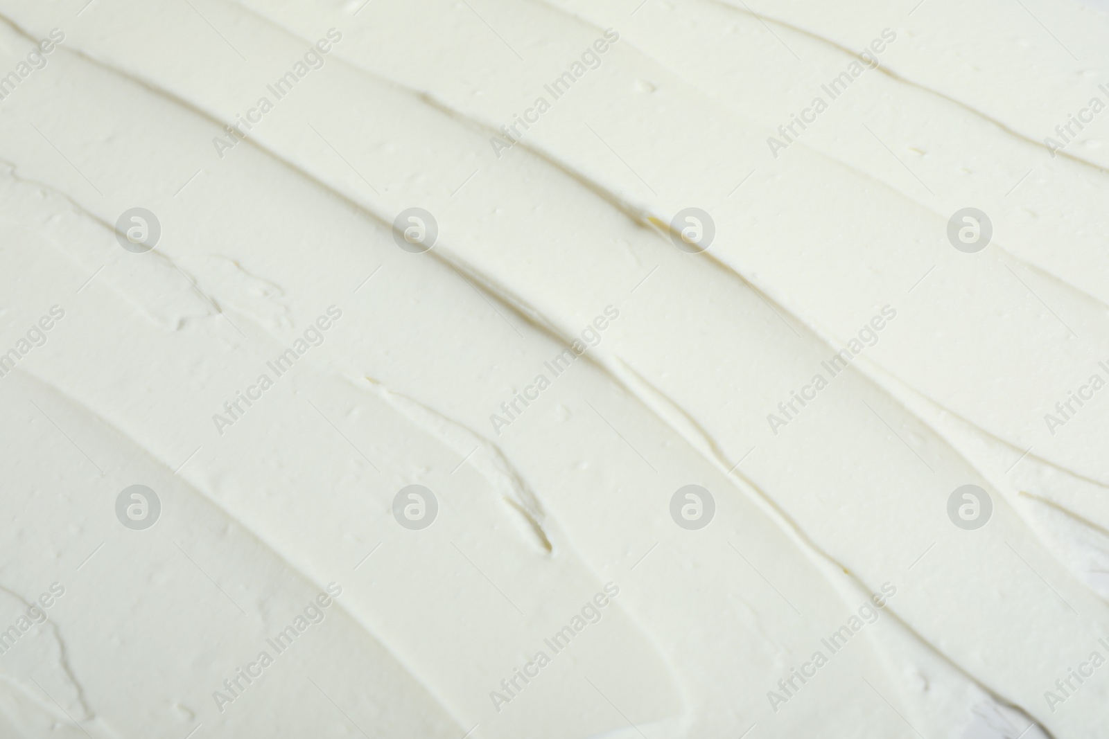 Photo of Tasty cream cheese as background, closeup view