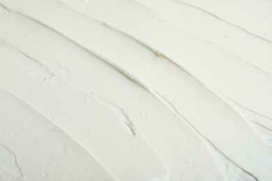 Photo of Tasty cream cheese as background, closeup view