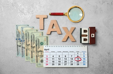 Photo of Flat lay composition with word TAX and money on grey background