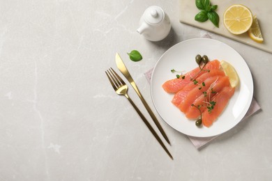 Delicious salmon carpaccio served on light grey table, flat lay. Space for text