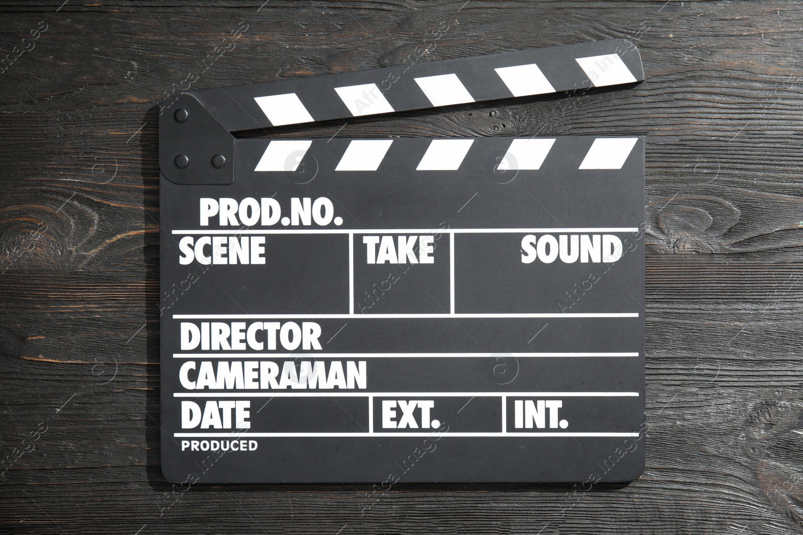 Photo of Clapperboard on wooden background, top view. Cinema production