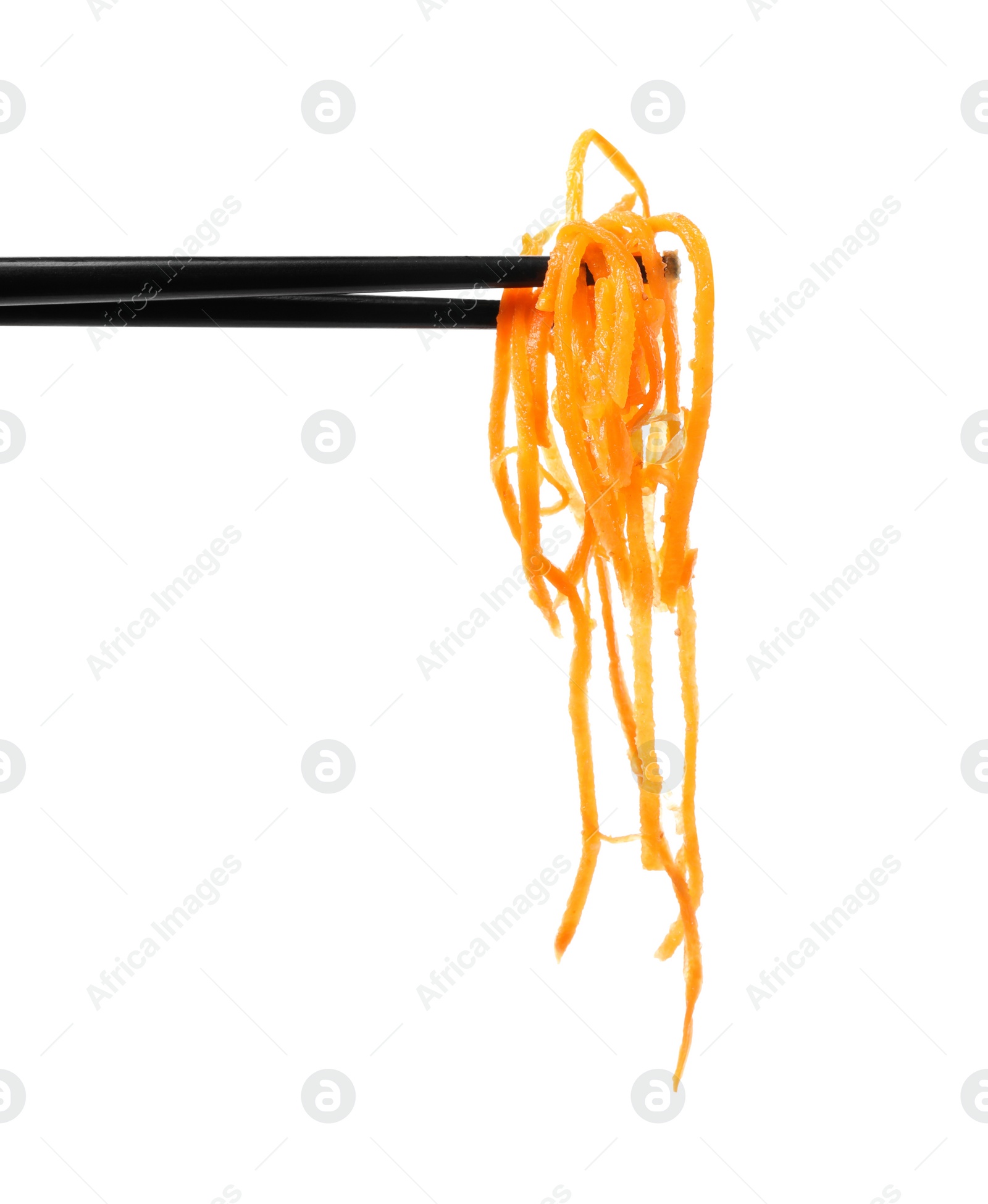 Photo of Chopsticks with delicious Korean carrot salad on white background