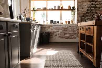 Photo of Stylish kitchen interior with modern furniture. Home design idea