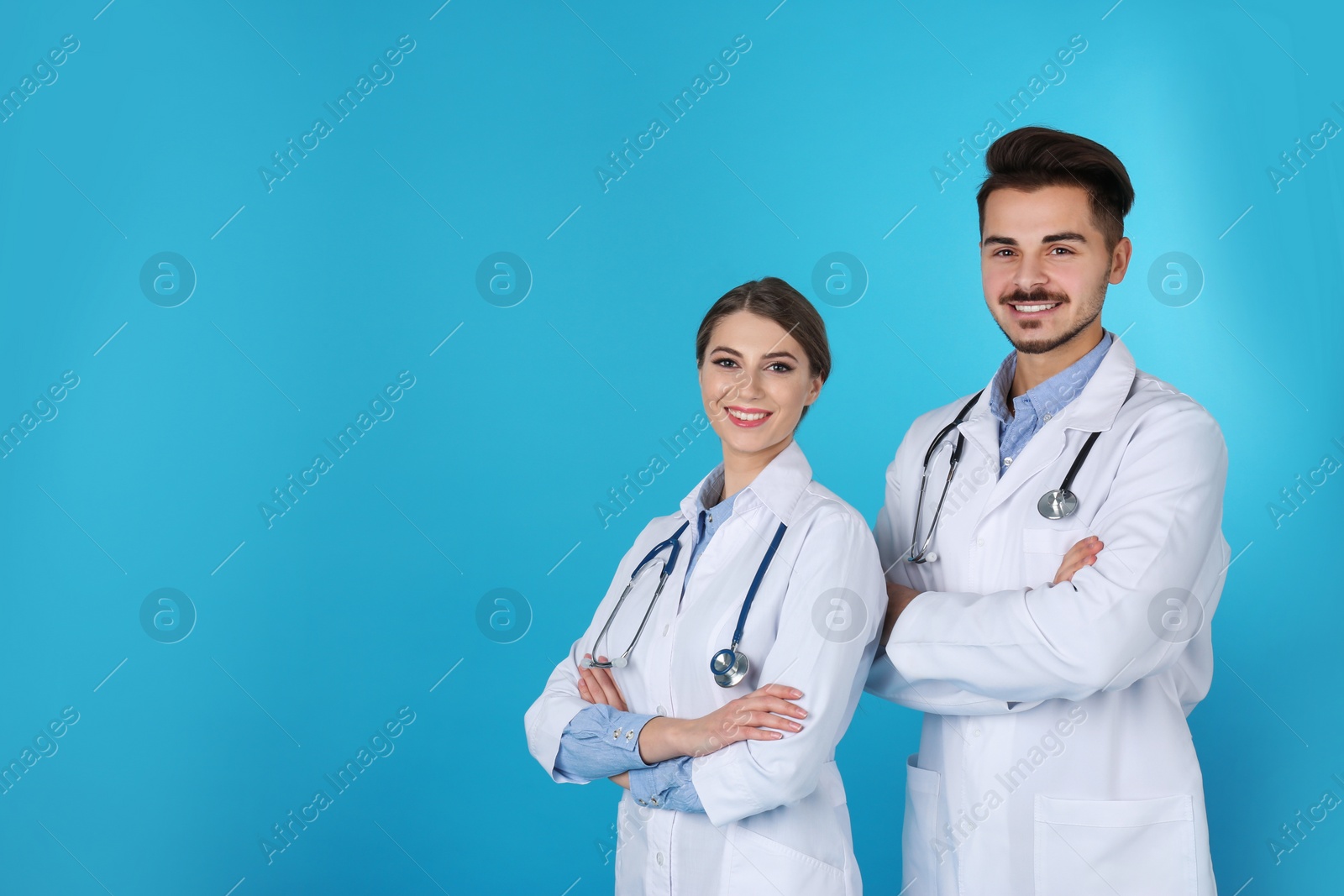 Photo of Happy young medical students on color background. Space for text