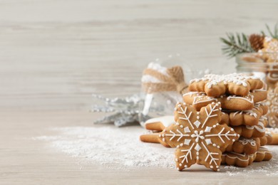 Photo of Tasty Christmas cookies on beige wooden table. Space for text