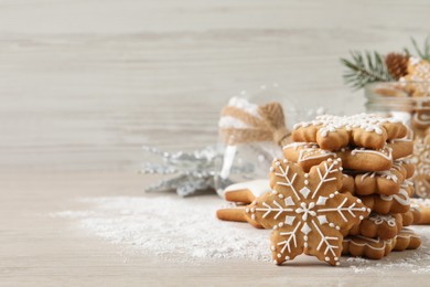 Tasty Christmas cookies on beige wooden table. Space for text