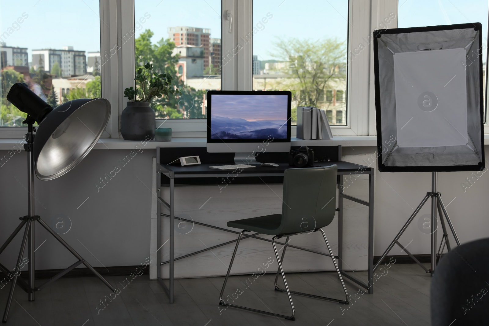 Photo of Professional lighting equipment and comfortable workplace in photo studio. Interior design