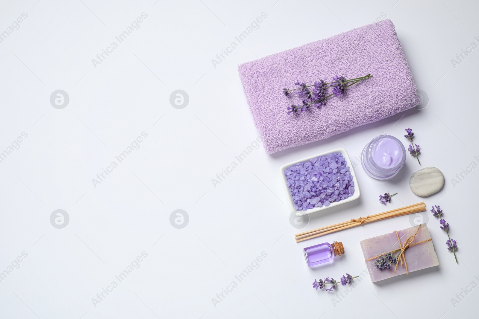 Photo of Cosmetic products and lavender flowers on white background, flat lay