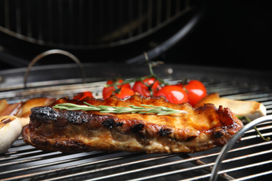 Photo of Delicious ribs with rosemary on barbecue grill, closeup