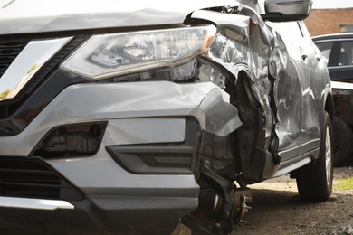 Photo of Broken car after road accident, closeup view. Auto insurance