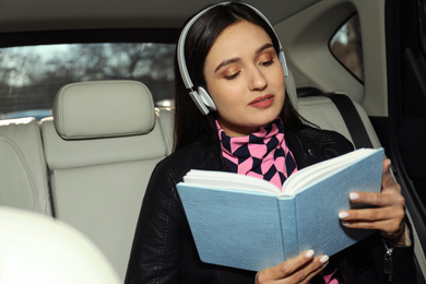 Young woman listening to audiobook in car