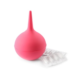 Photo of Pink enema and suppositories on white background
