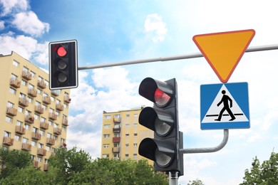 Photo of Different road signs and traffic lights on city street
