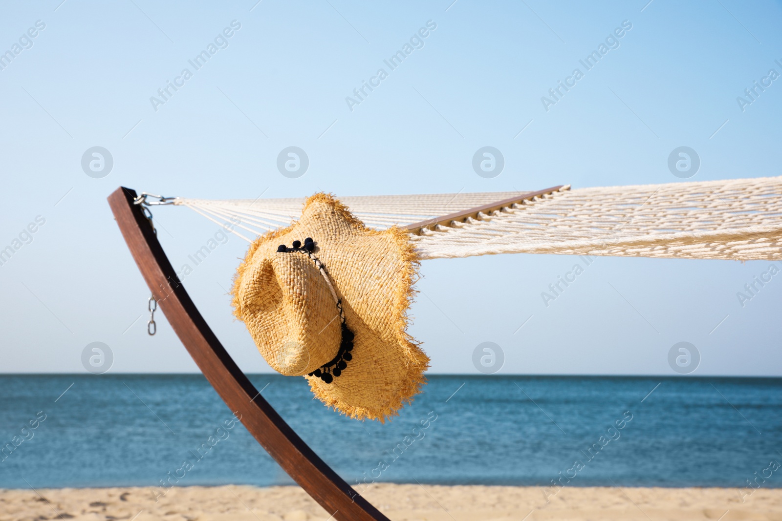 Photo of Hammock and hat at seaside. Time to relax