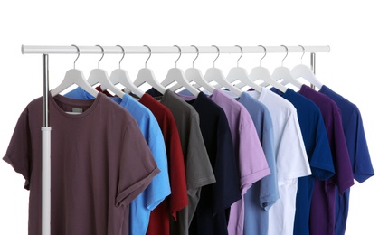 Men clothes hanging on wardrobe rack against white background