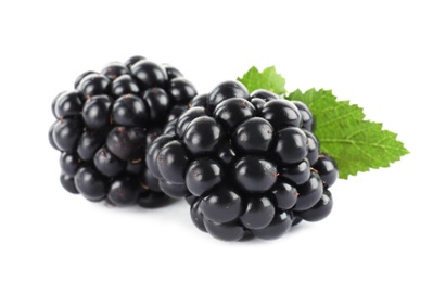 Tasty ripe blackberries and leaves on white background