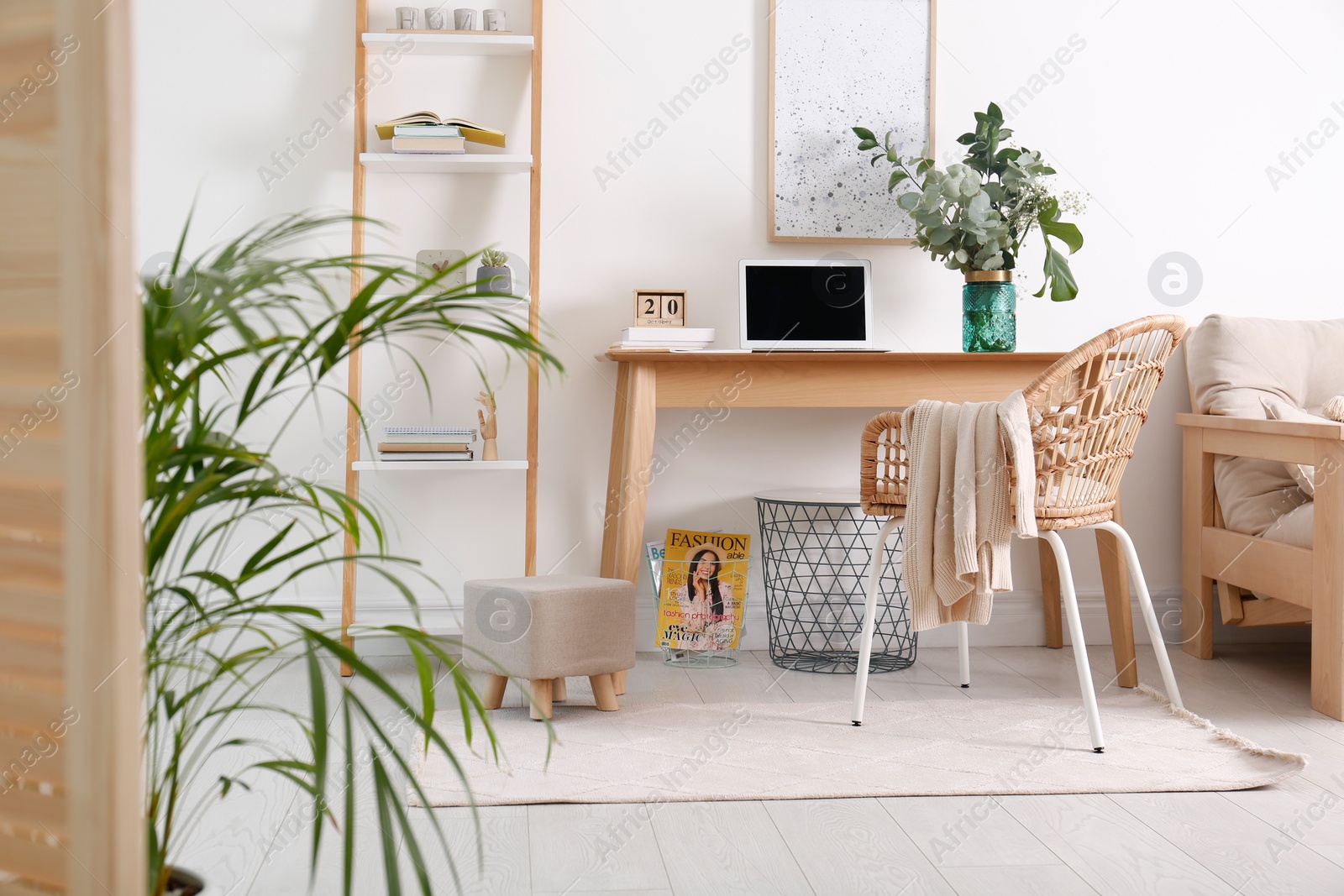 Photo of Stylish ottoman on floor in modern home office. Interior design