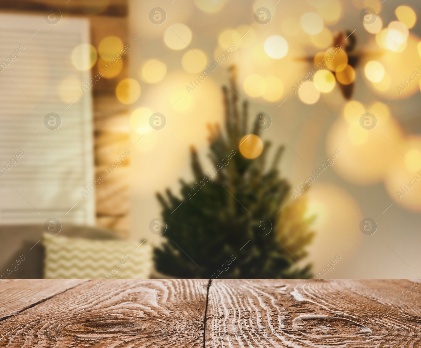 Image of Empty wooden surface and blurred view of Christmas tree in room, space for text. Interior design