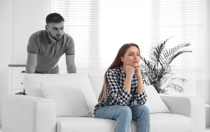 Image of Unhappy young couple with relationship problems at home. Cheating and breakup