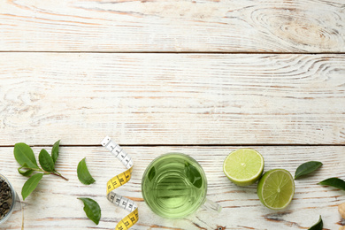 Flat lay composition with diet herbal tea on white wooden background, space for text