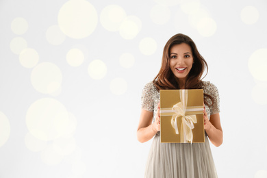 Photo of Beautiful woman with Christmas gift on white background