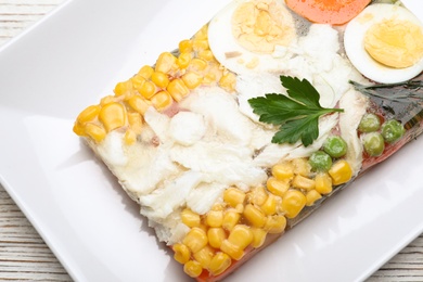 Delicious fish aspic on plate, top view