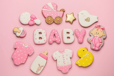 Word BABY and tasty cookies on pink background, flat lay