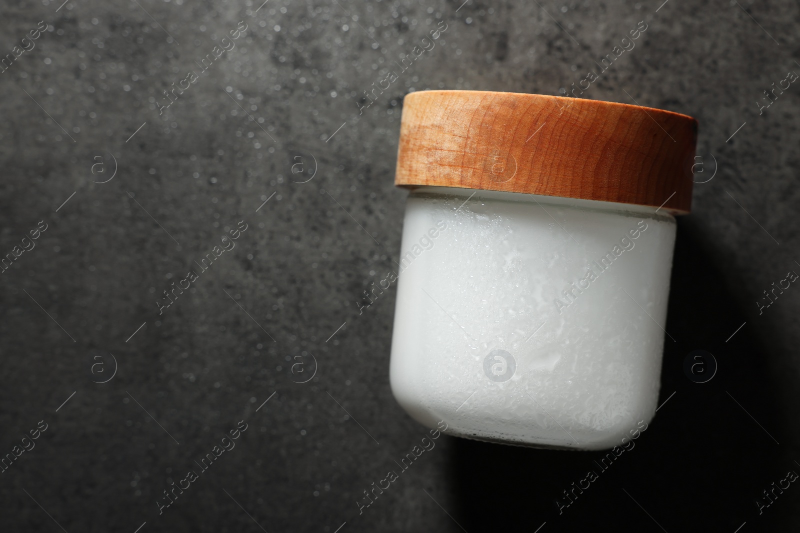 Photo of Jar of cosmetic product on grey background, top view. Space for text