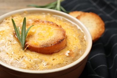 Photo of Tasty homemade french onion soup on table, closeup