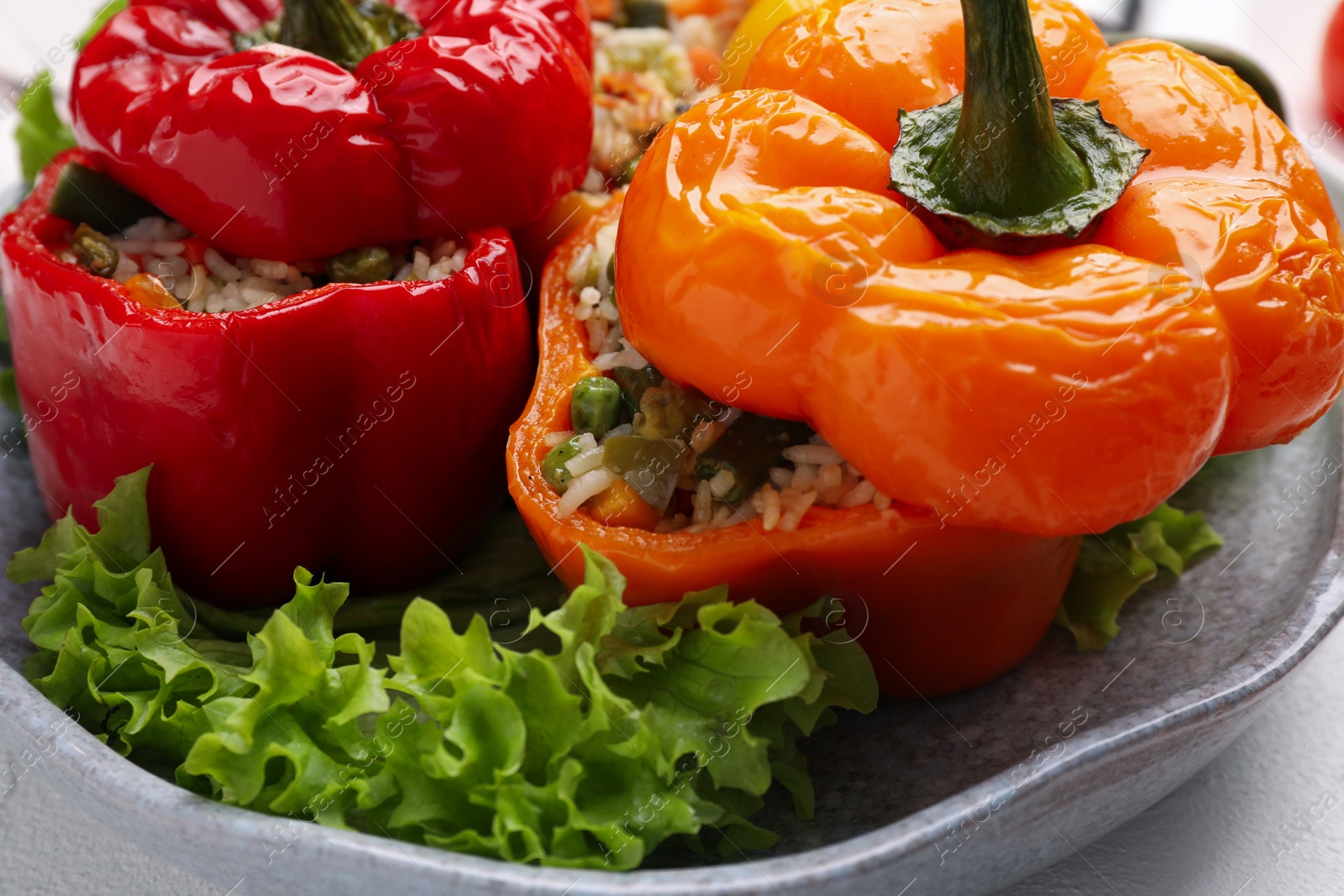 Photo of Tasty stuffed bell peppers on table, closeup