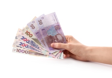 Photo of Woman holding Ukrainian money on white background, closeup
