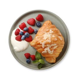 Photo of Delicious croissant, berries and cream cheese isolated on white, top view