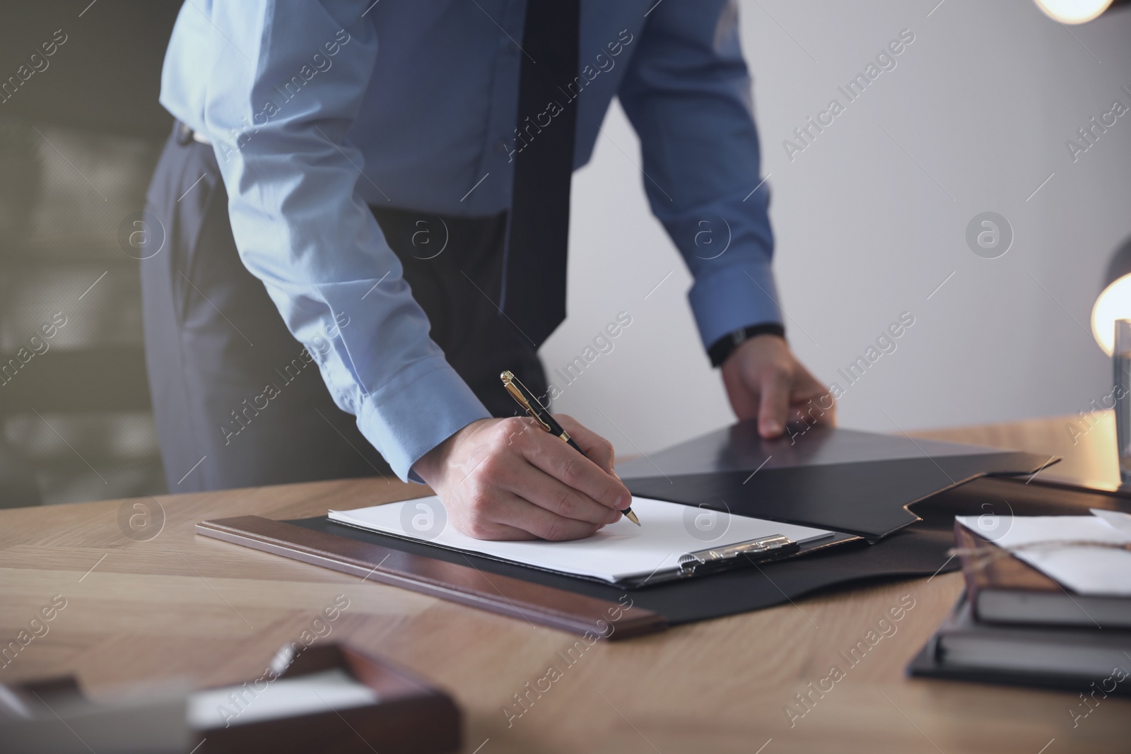 Photo of Male lawyer working at table in office, closeup