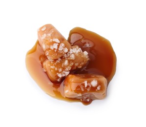 Yummy caramel candies and sea salt isolated on white, top view