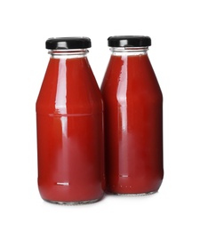 Photo of Bottles with tomato juice isolated on white