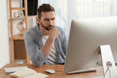 Online test. Man studying with computer at home