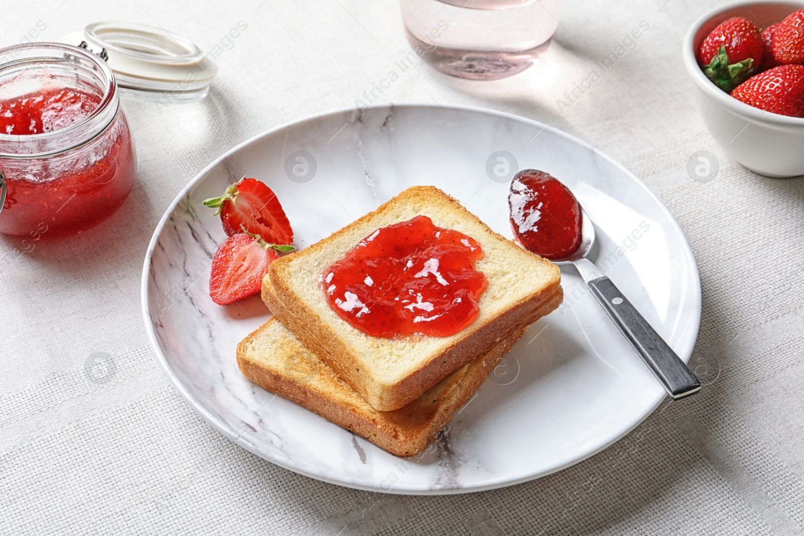 Photo of Toast bread with strawberry jam on table