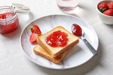 Photo of Toast bread with strawberry jam on table