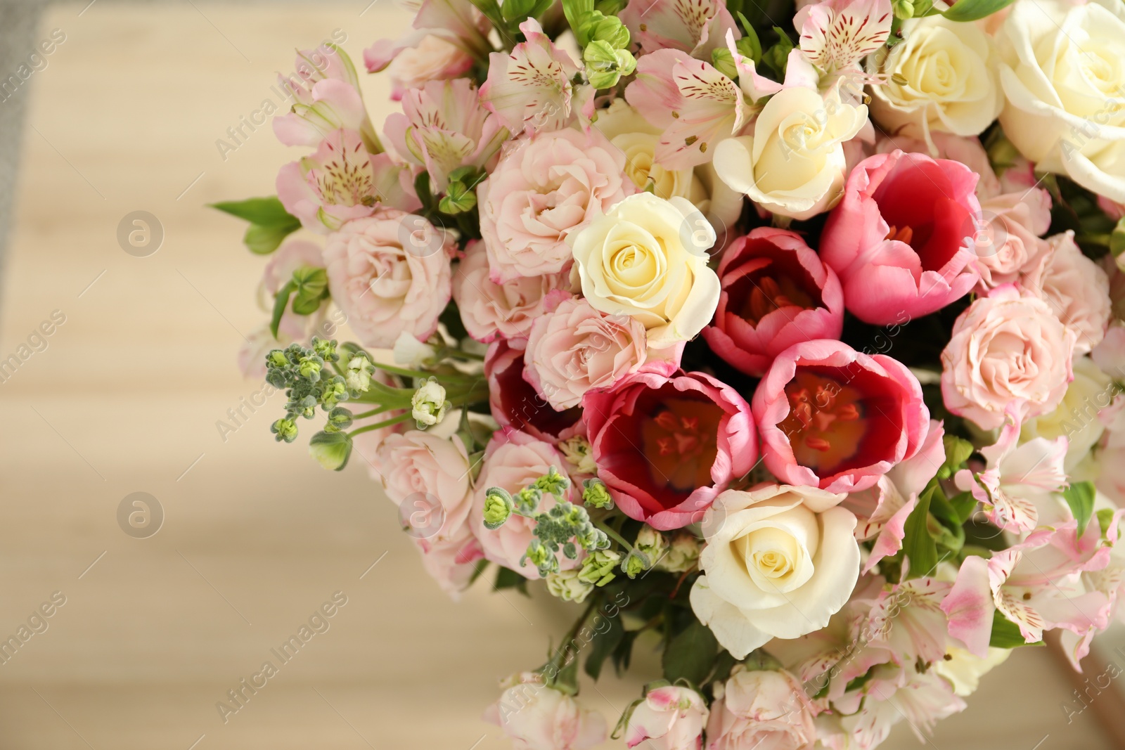 Photo of Beautiful bouquet of fresh flowers on table indoors, closeup