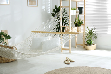 Photo of Comfortable hammock in stylish room. Interior design